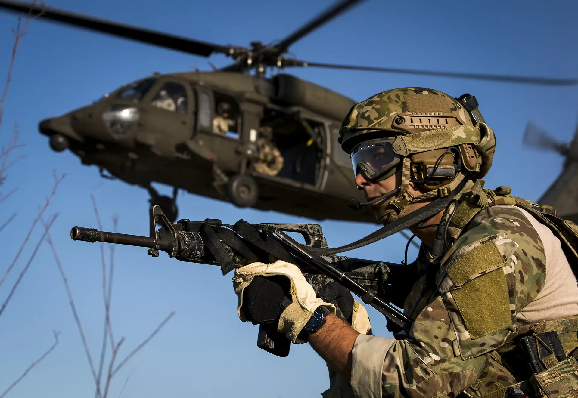 Special tactics airman training beside a Black Hawk